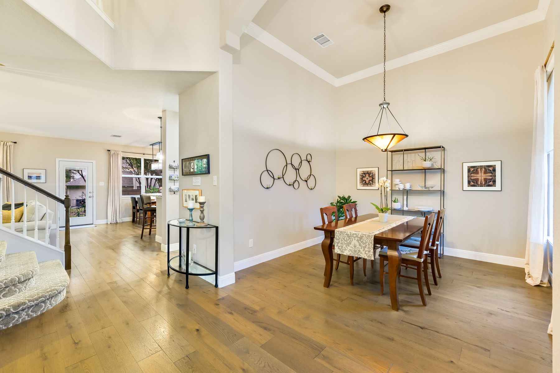 300 River Ridge Drive Georgetown, TX 78628 - Photo 6 of 32 Dining room with stairs, high vaulted ceiling, light wood-style floors, and ornamental molding