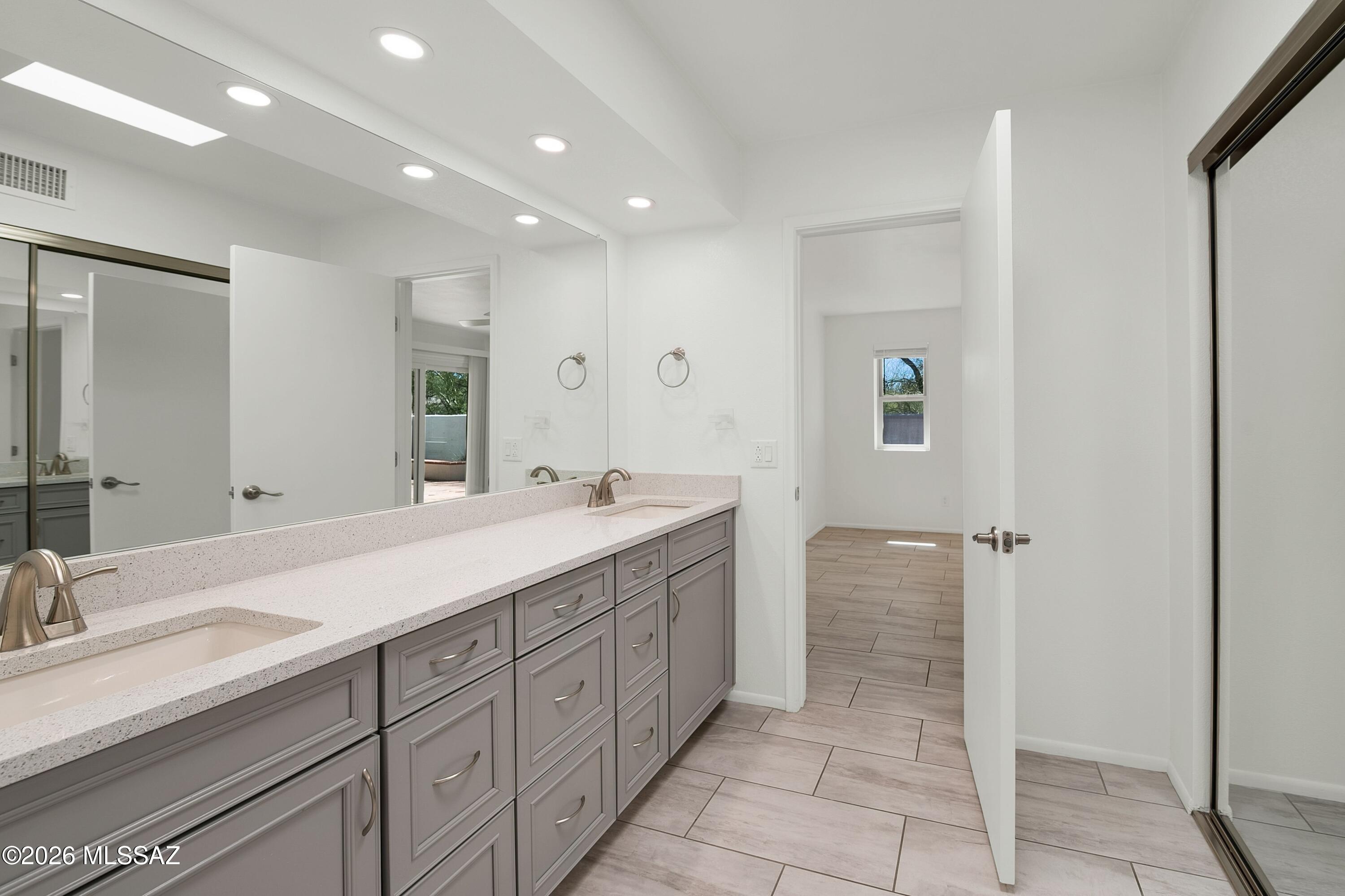 7408 East Wandering Road Tucson, AZ 85750 - Photo 16 of 25 a spacious bathroom with a double vanity sink mirror and double