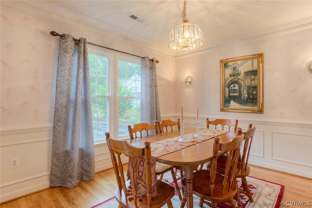 5501 Windy Ridge Court Midlothian, VA 23112 - Photo 10 of 31 a dining room with furniture a chandelier and wooden floor