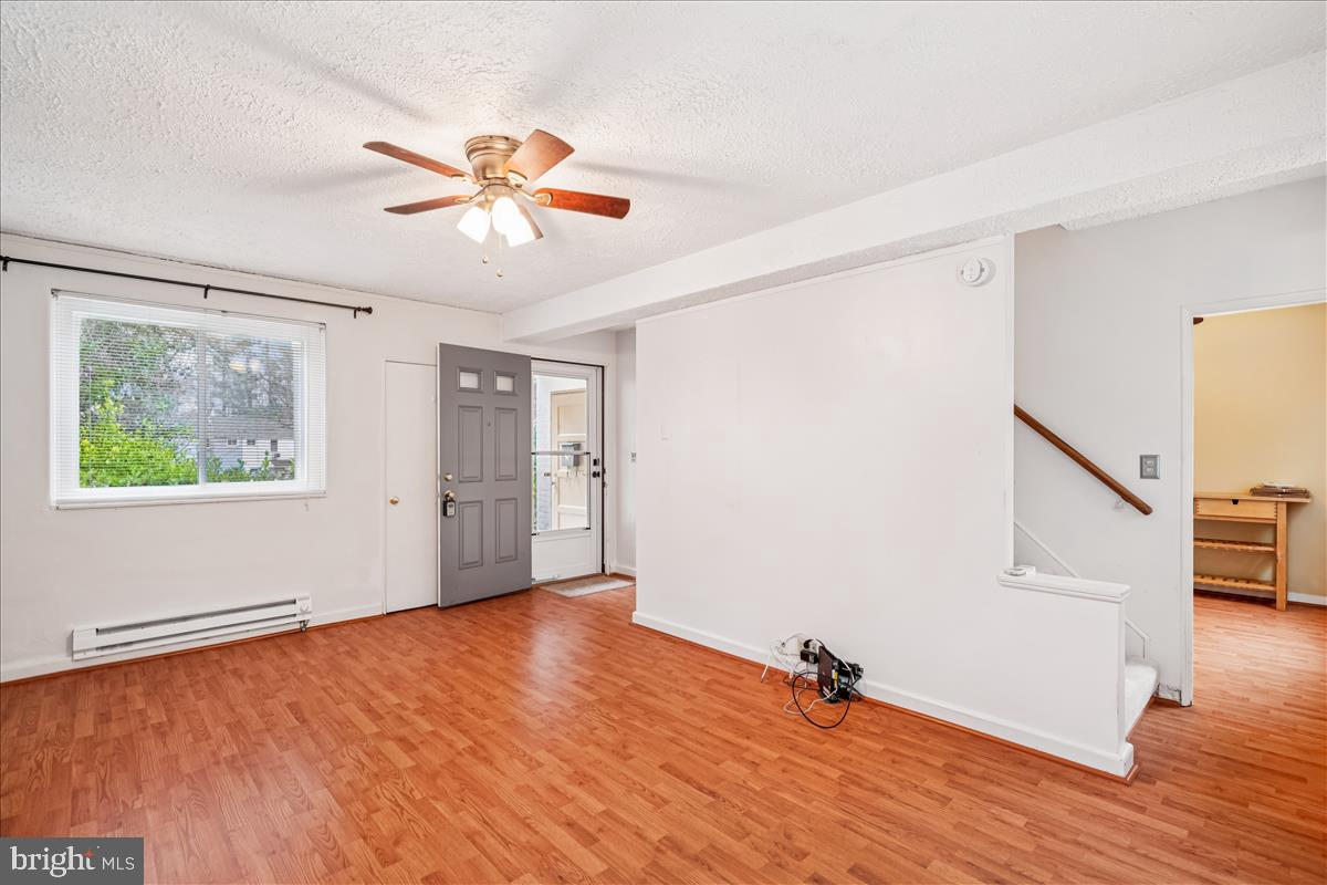 47 Ridge Road Greenbelt, MD 20770 - Photo 16 of 38 a view of empty room with wooden floor and fan