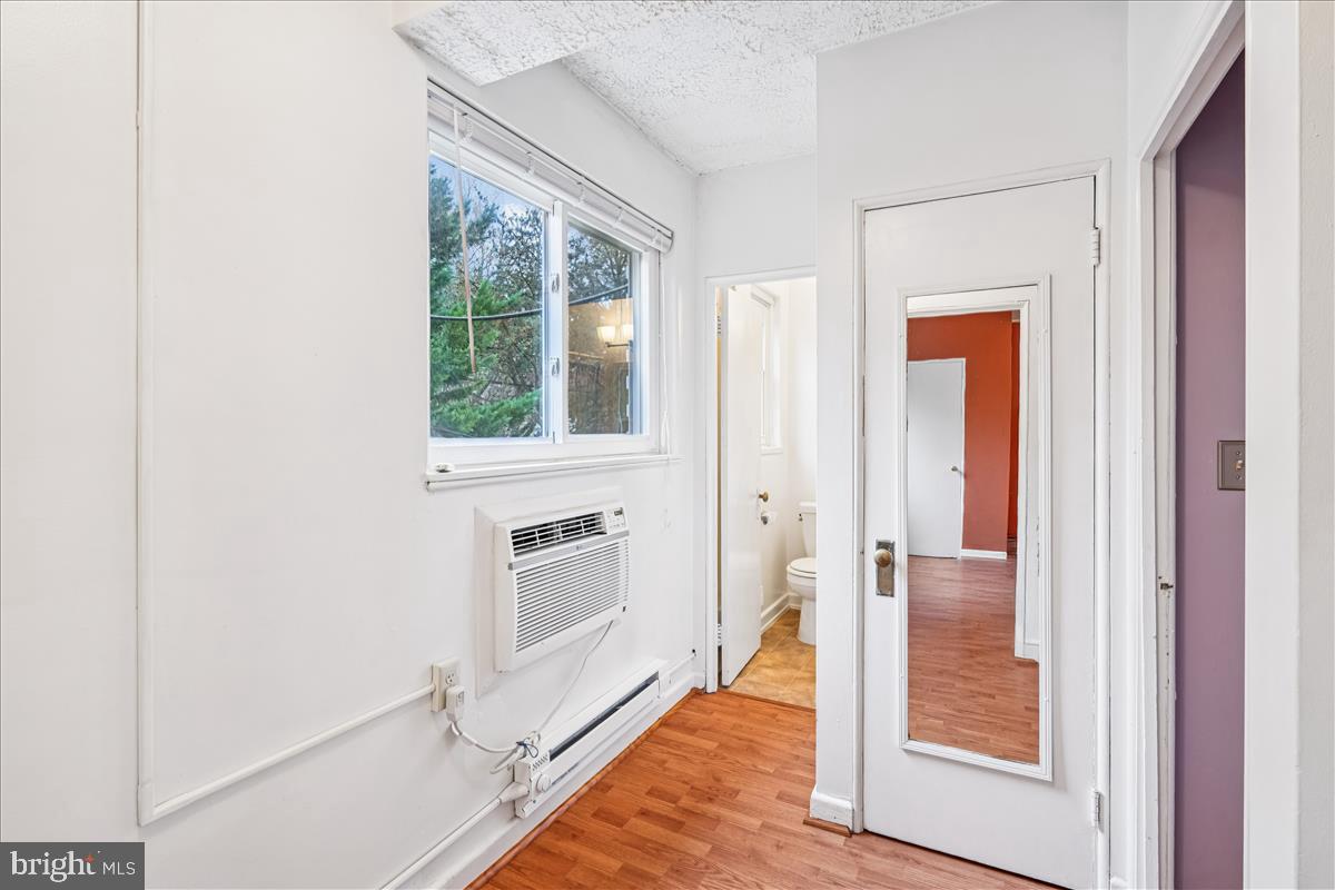 47 Ridge Road Greenbelt, MD 20770 - Photo 27 of 38 a view of a hallway with wooden floor and a living room
