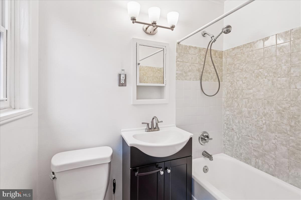 47 Ridge Road Greenbelt, MD 20770 - Photo 30 of 38 a bathroom with a sink a toilet and shower