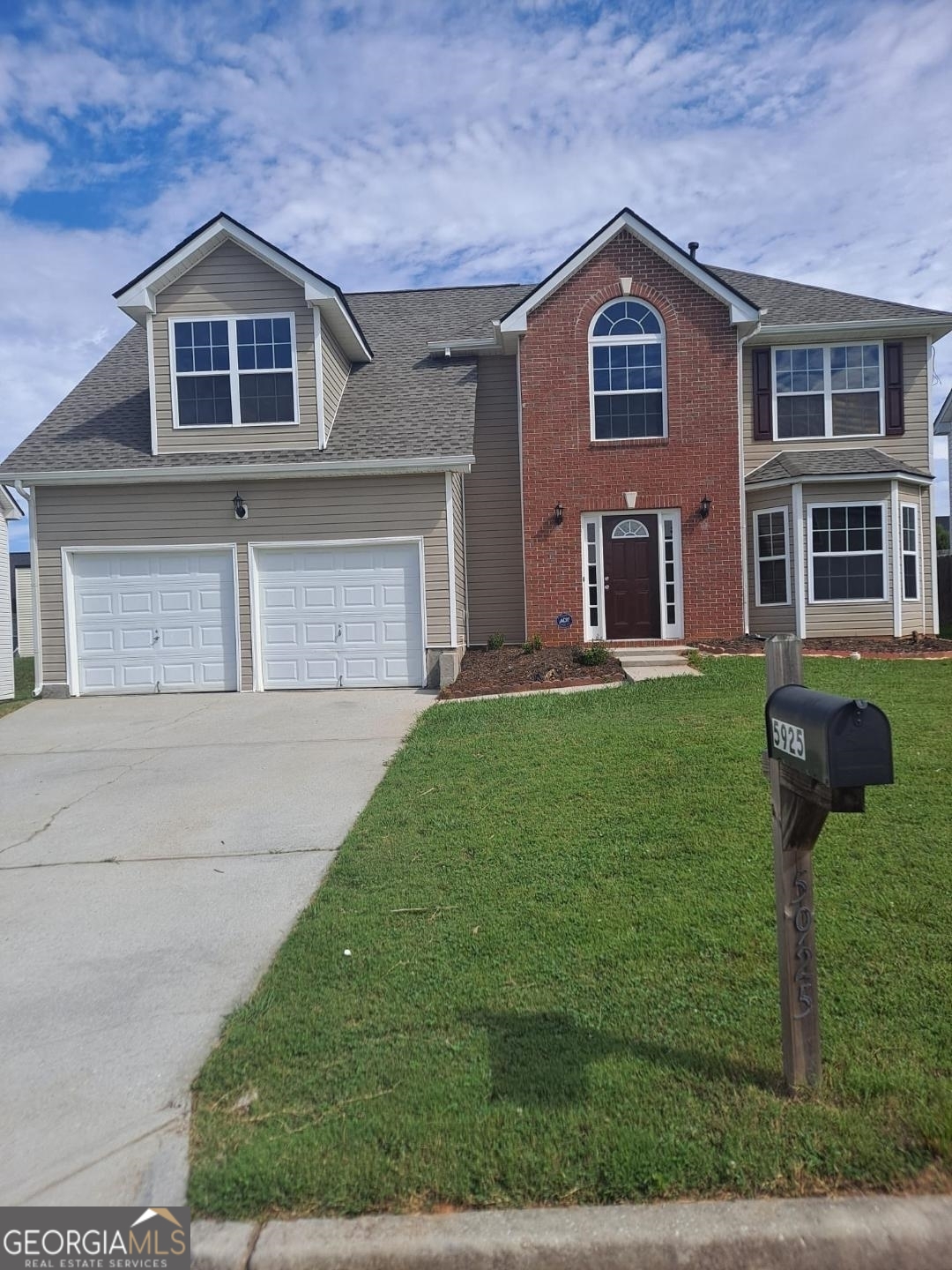 5925 Bluegrass View Fairburn, GA 30213 - Photo 1 of 1 a front view of a house with garden