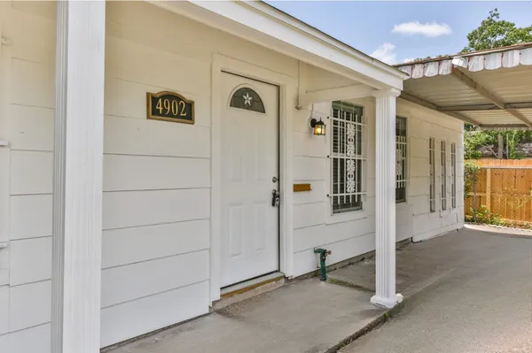 a view of a house with a yard balcony and wooden floor