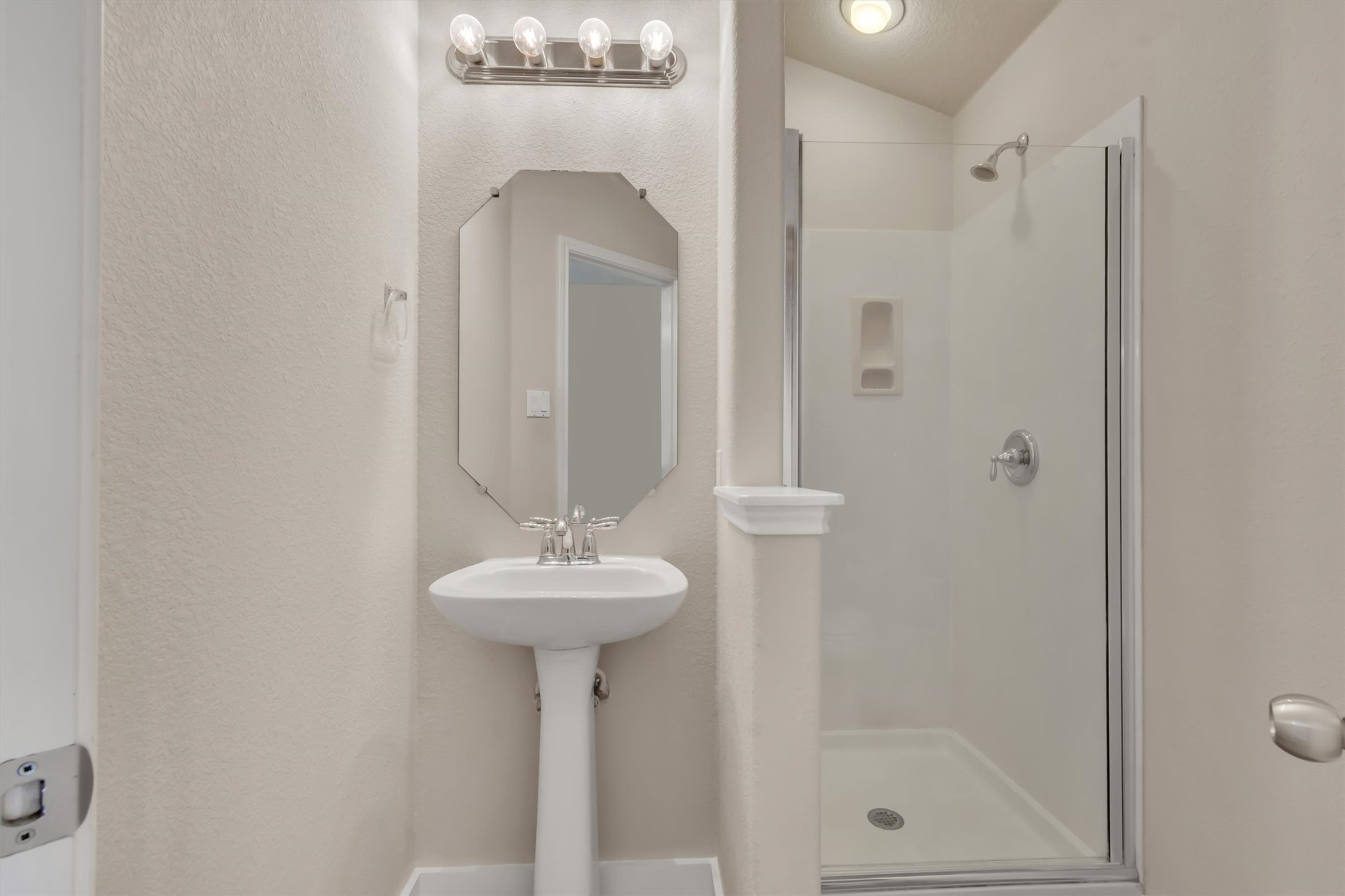 14815 Avery Ranch Boulevard, Unit 2A Austin, TX 78717 - Photo 12 of 27 A well-lit, contemporary bath features a pedestal sink and walk-in shower.
