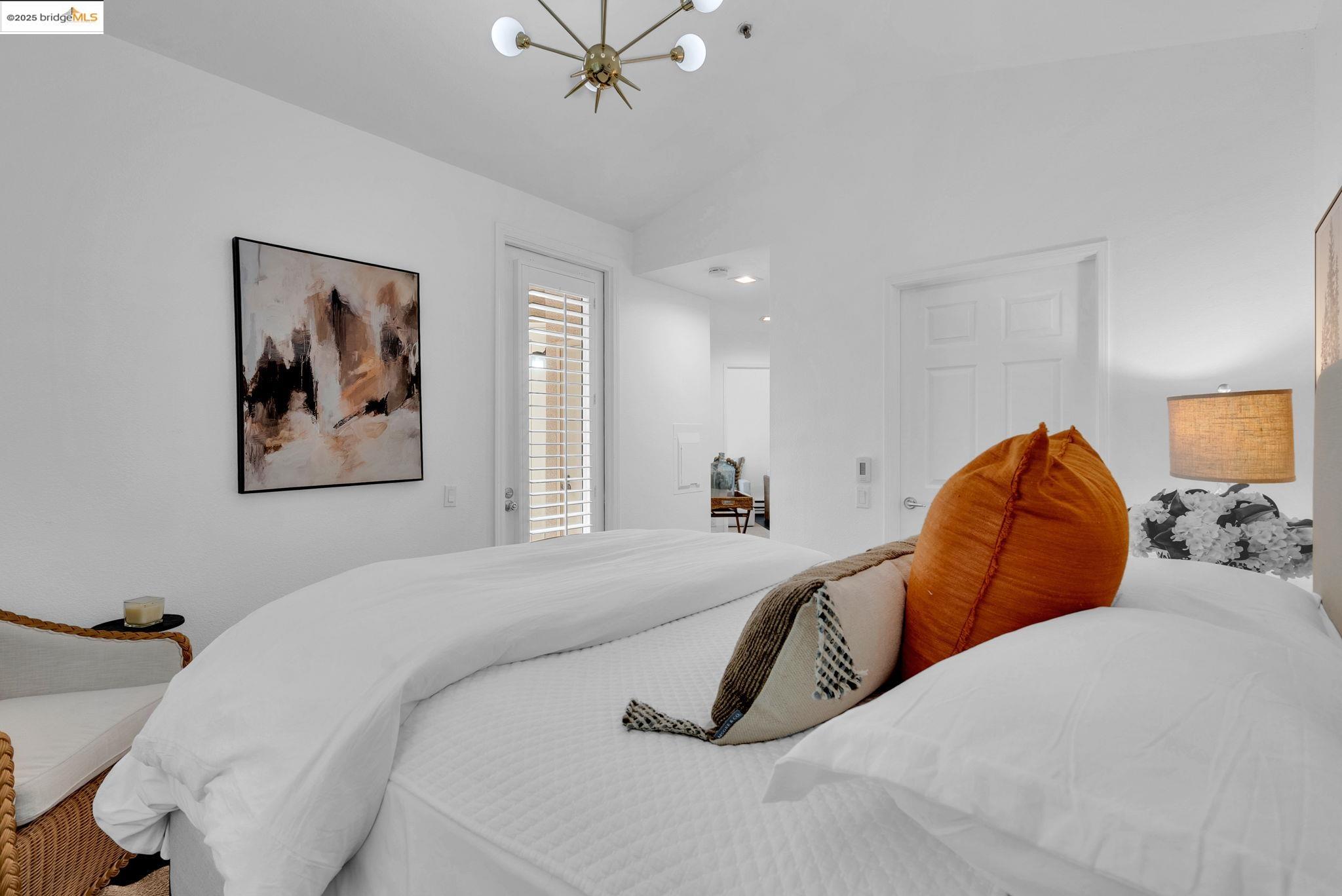 180 Caldecott Lane, Unit U314 Oakland, CA 94618 - Photo 11 of 26 Bedroom featuring a chandelier and vaulted ceiling