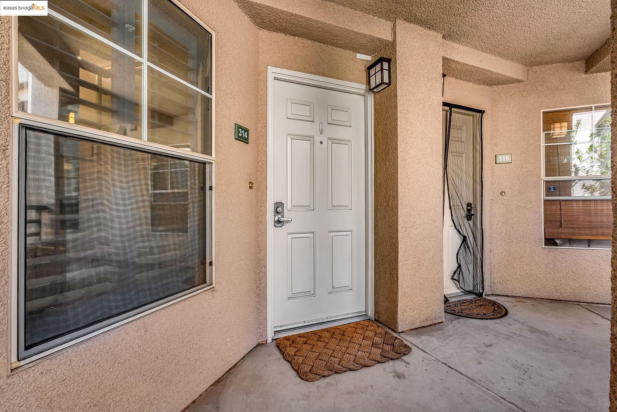 180 Caldecott Lane, Unit U314 Oakland, CA 94618 - Photo 14 of 26 Doorway to property with stucco siding