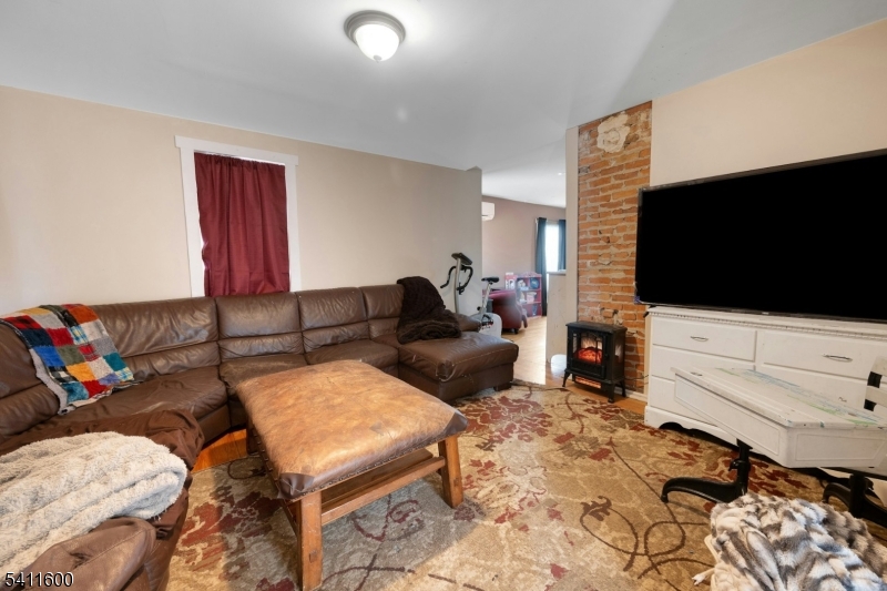 6 Madison Street Newton, NJ 07860 - Photo 20 of 28 a living room with furniture and a flat screen tv