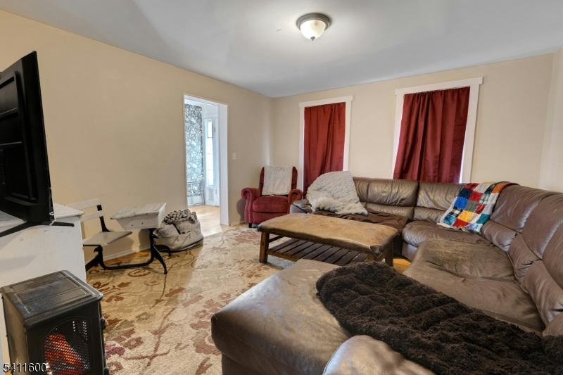 6 Madison Street Newton, NJ 07860 - Photo 21 of 28 a living room with furniture and a flat screen tv