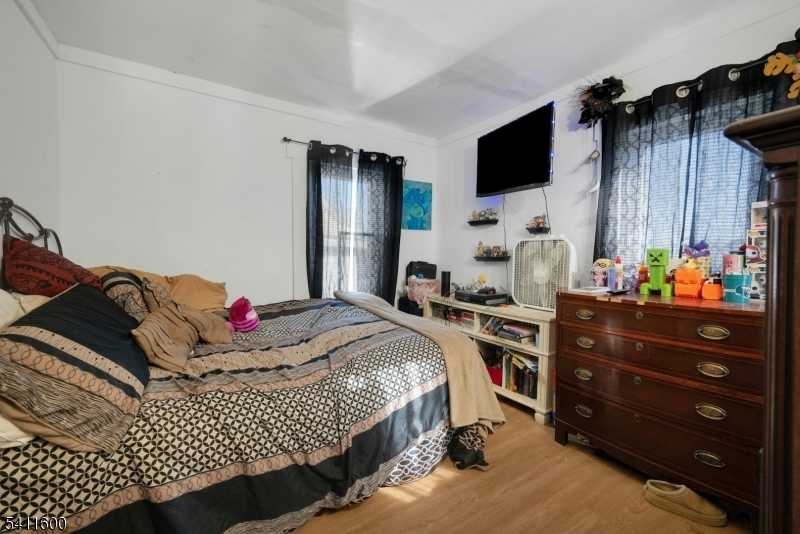 6 Madison Street Newton, NJ 07860 - Photo 23 of 28 a bedroom with a bed and flat screen tv