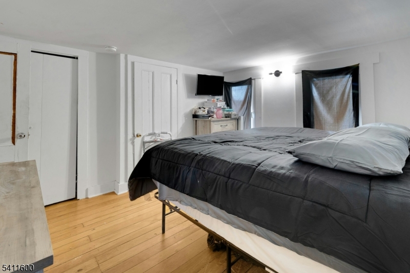 6 Madison Street Newton, NJ 07860 - Photo 26 of 28 a bedroom with a bed and wooden floor