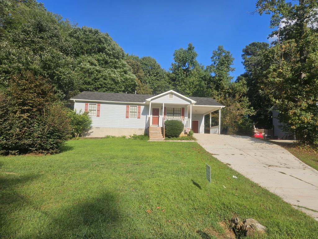 a front view of house with yard and green space