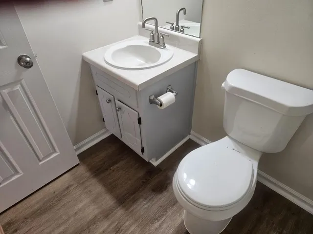 a bathroom with a toilet sink and mirror