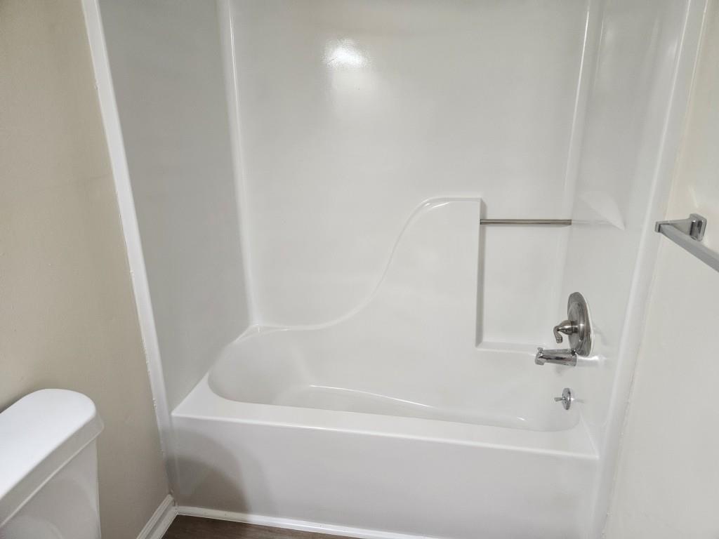 4121 Burgundy Way Flowery Branch, GA 30542 - Photo 12 of 15 a white bath tub sitting next to a white toilet and sink