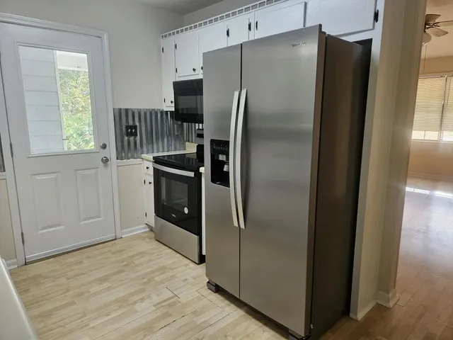 a kitchen with stainless steel appliances granite countertop a refrigerator and a sink