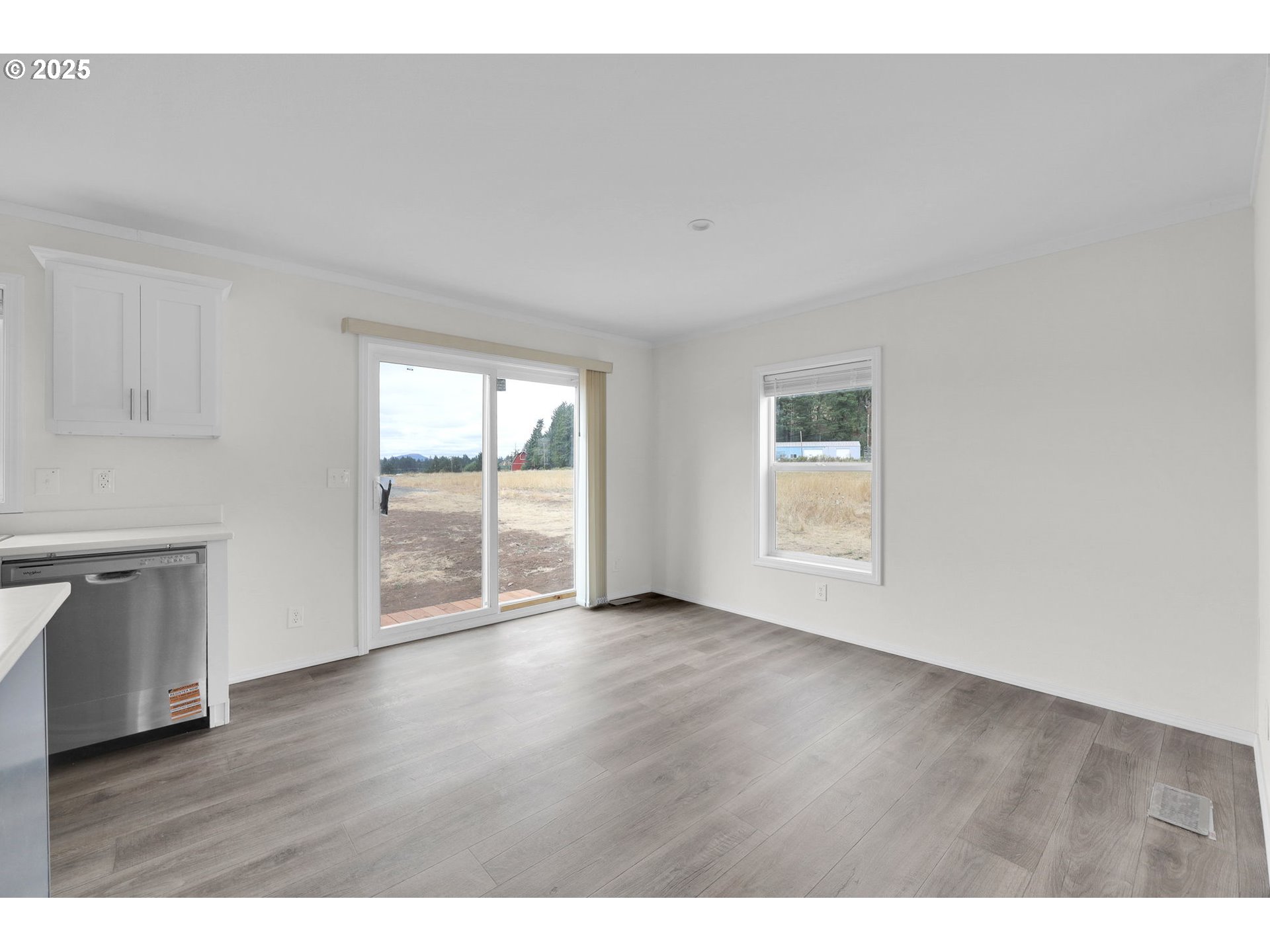 89615 Hill Road Springfield, OR 97478 - Photo 7 of 44 a view of an empty room with wooden floor and a window