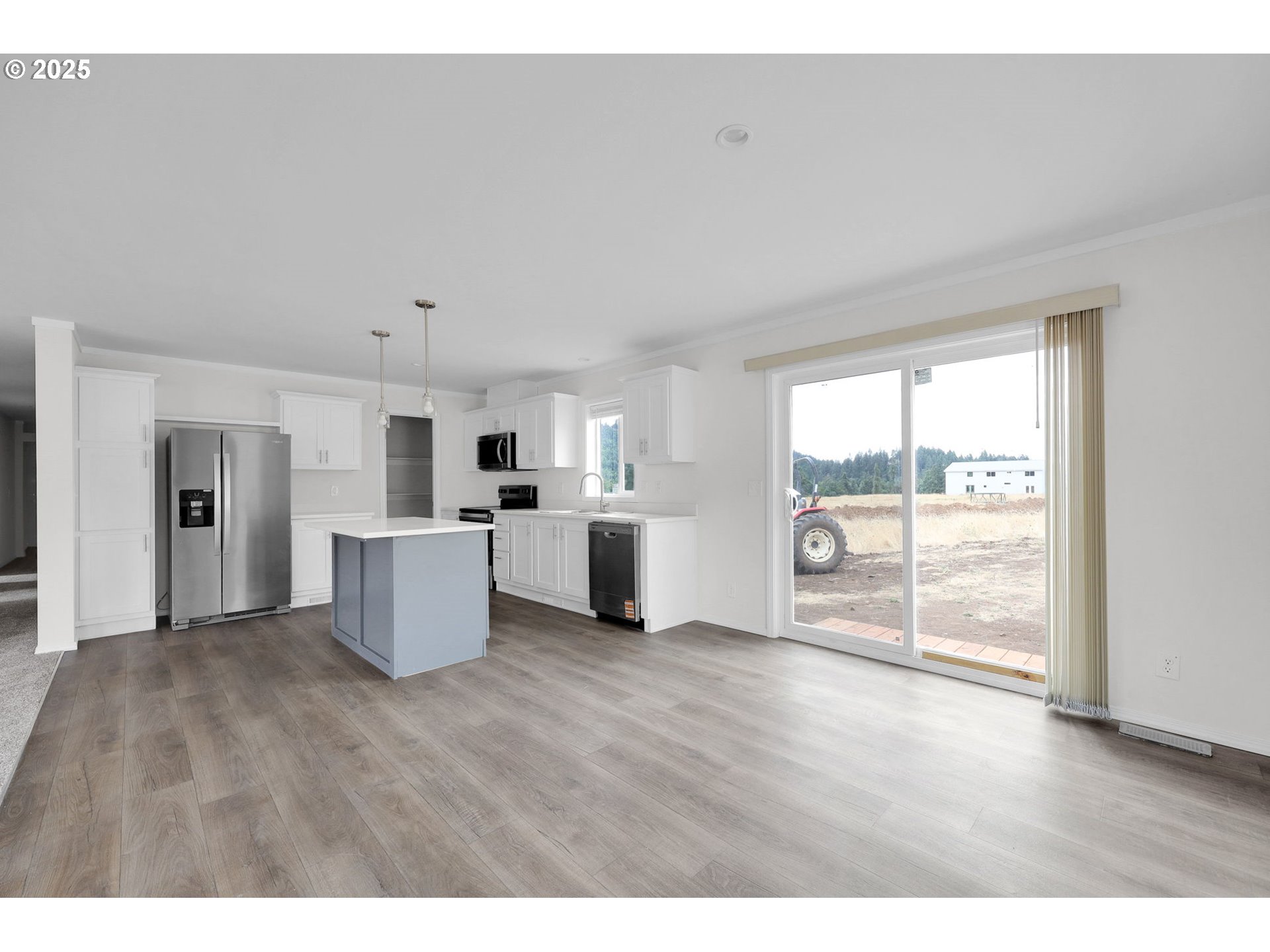 89615 Hill Road Springfield, OR 97478 - Photo 8 of 44 a open kitchen with white cabinets and wooden floor