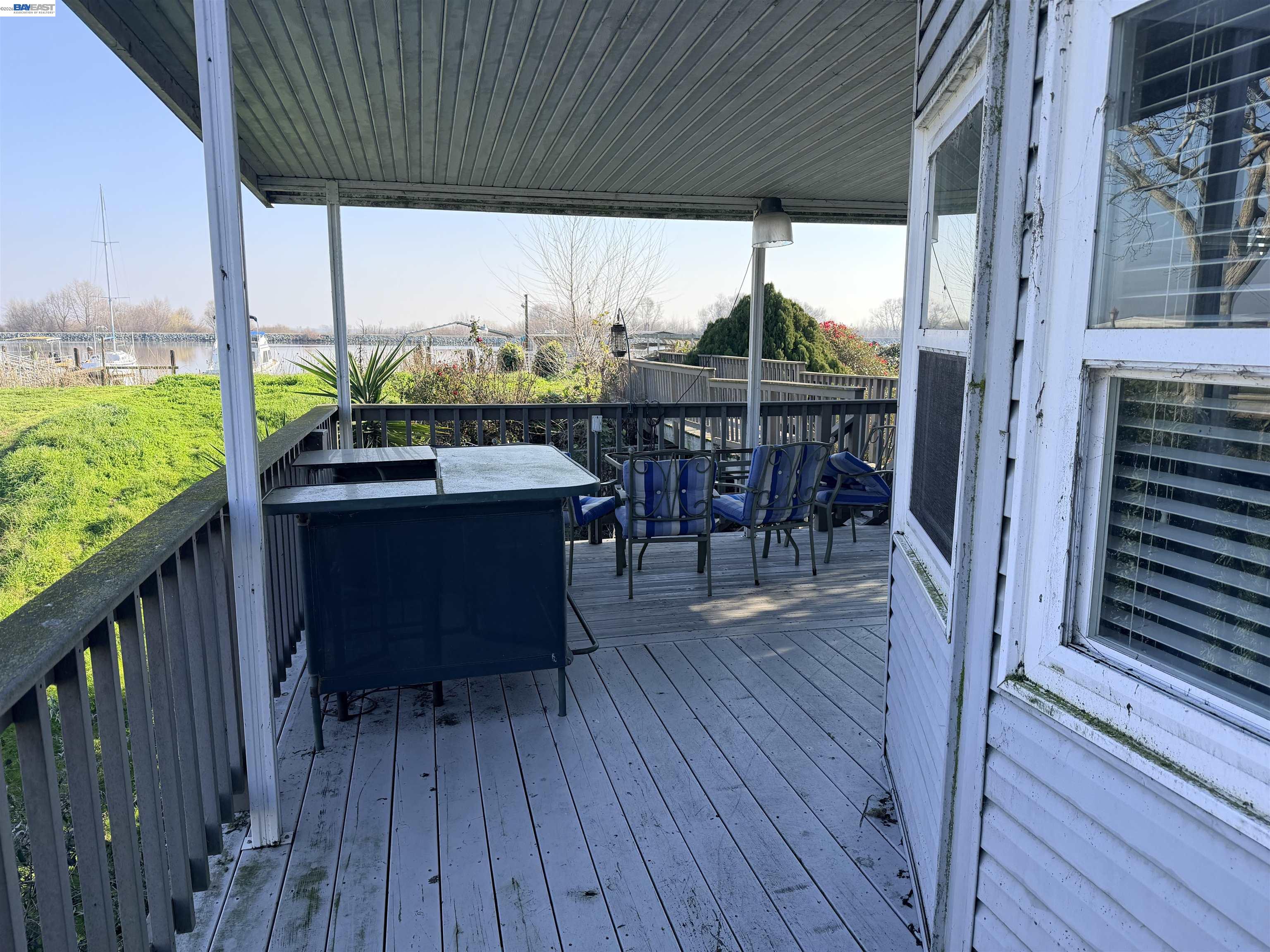 4526 Windsweep Road Bethel Island, CA 94511 - Photo 2 of 41 a view of a patio with table and chairs potted plants with wooden floor