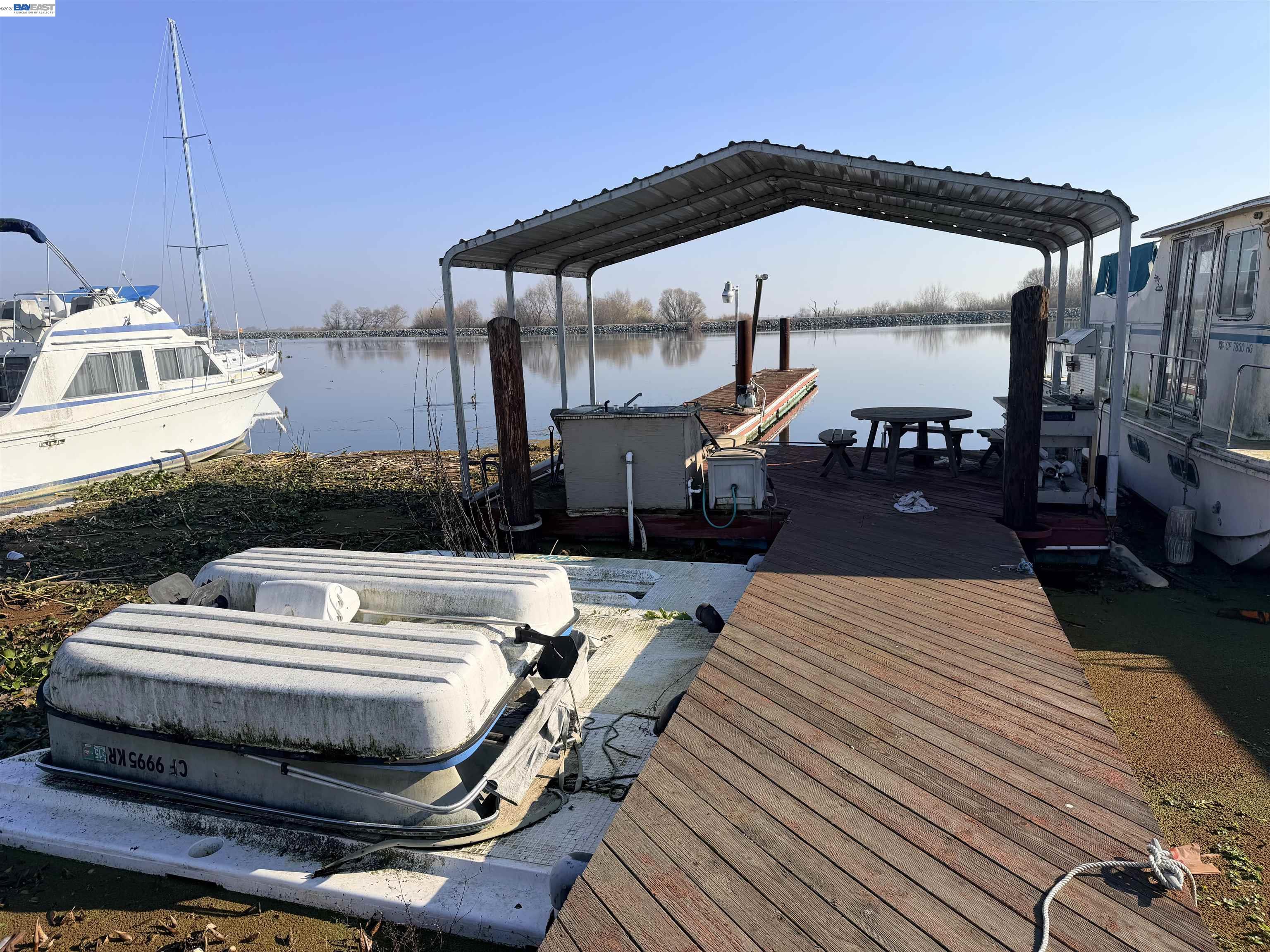 4526 Windsweep Road Bethel Island, CA 94511 - Photo 35 of 41 a view of a roof deck with table and chairs a barbeque with wooden floor and fence
