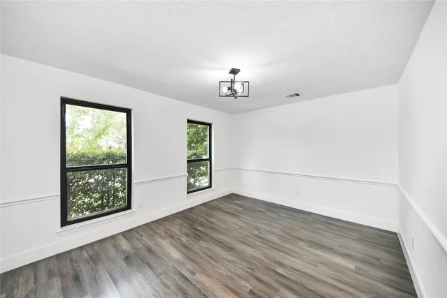 an empty room with windows and closet