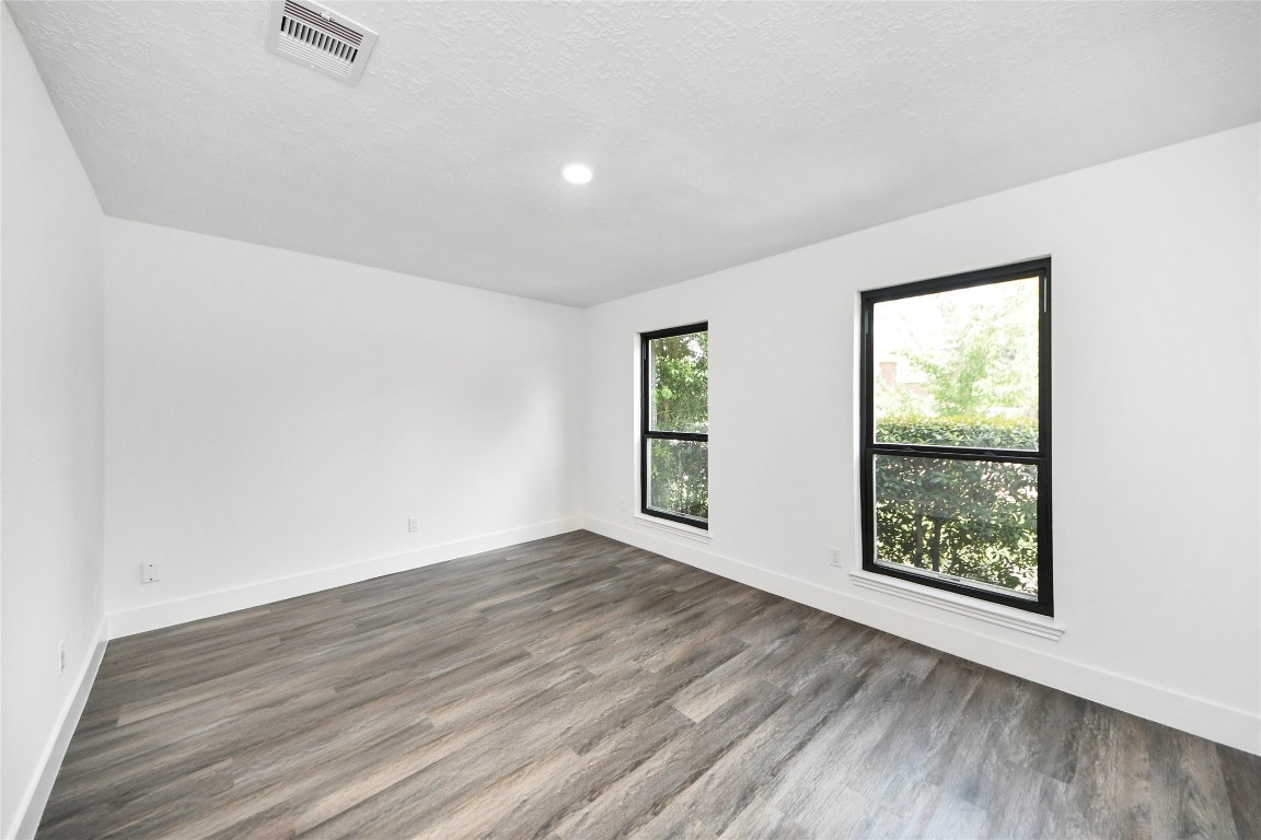 8510 Canyon Pine Drive Spring, TX 77379 - Photo 19 of 42 an empty room with wooden floor and windows