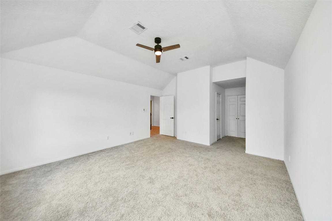 8510 Canyon Pine Drive Spring, TX 77379 - Photo 24 of 42 an empty room with a ceiling fan and carpet