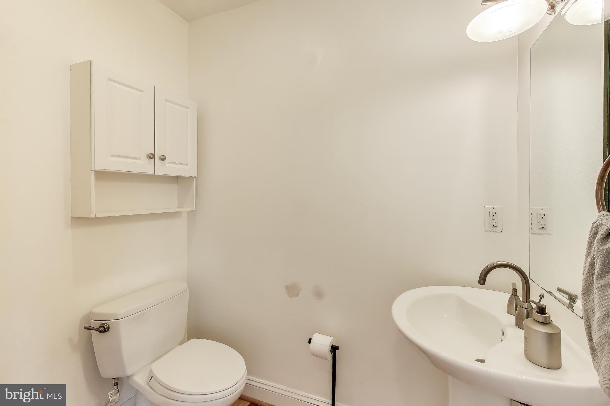 1406 T Street Northwest, Unit 6 Washington, DC 20009 - Photo 15 of 31 a bathroom with a sink a toilet and mirror