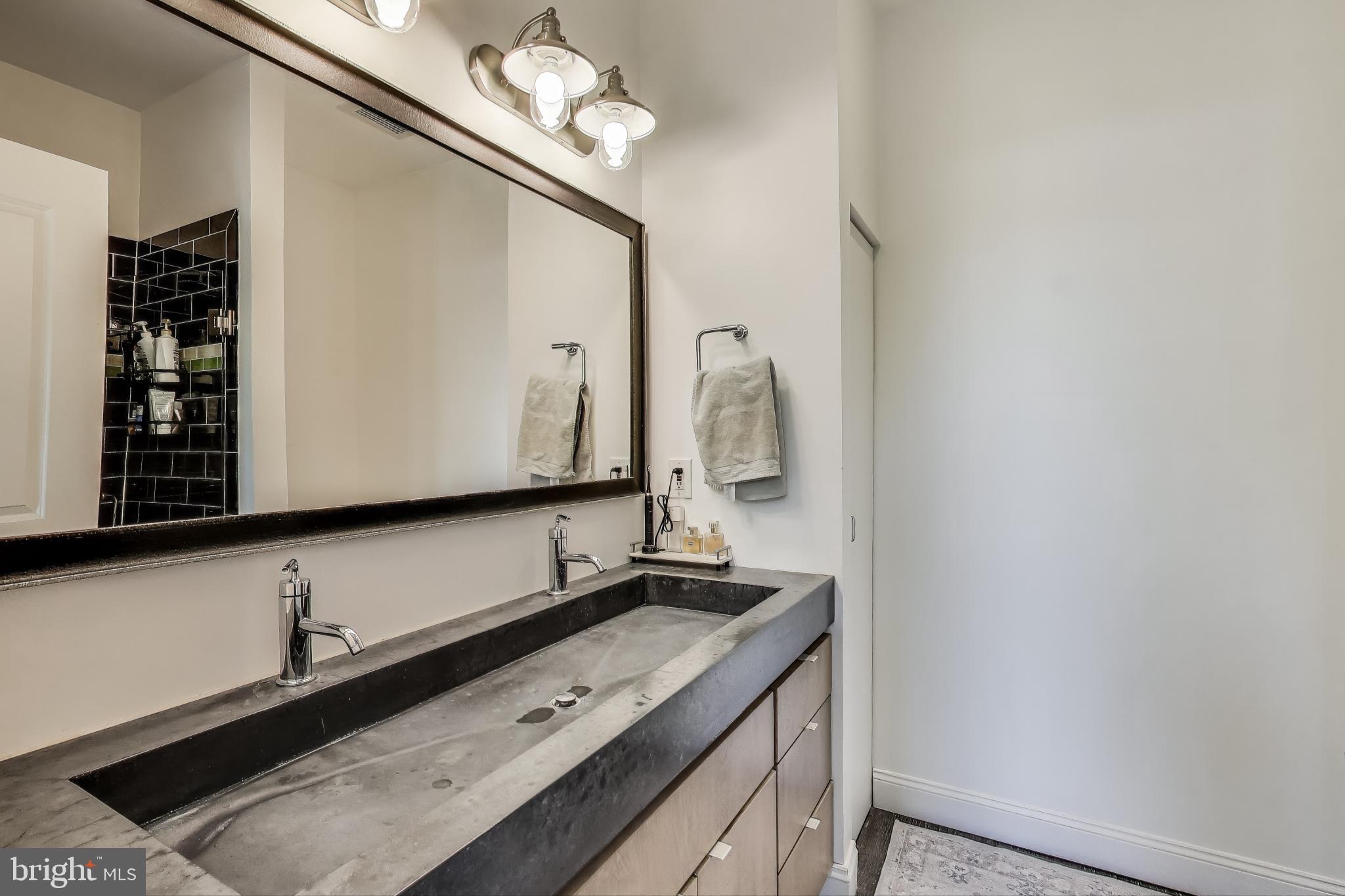 1406 T Street Northwest, Unit 6 Washington, DC 20009 - Photo 21 of 31 a bathroom with a double vanity sink and a mirror
