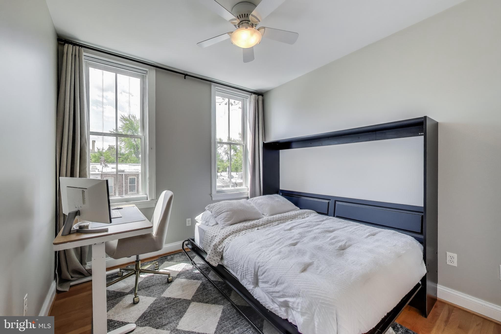 1406 T Street Northwest, Unit 6 Washington, DC 20009 - Photo 24 of 31 a bedroom with a bed and a chandelier