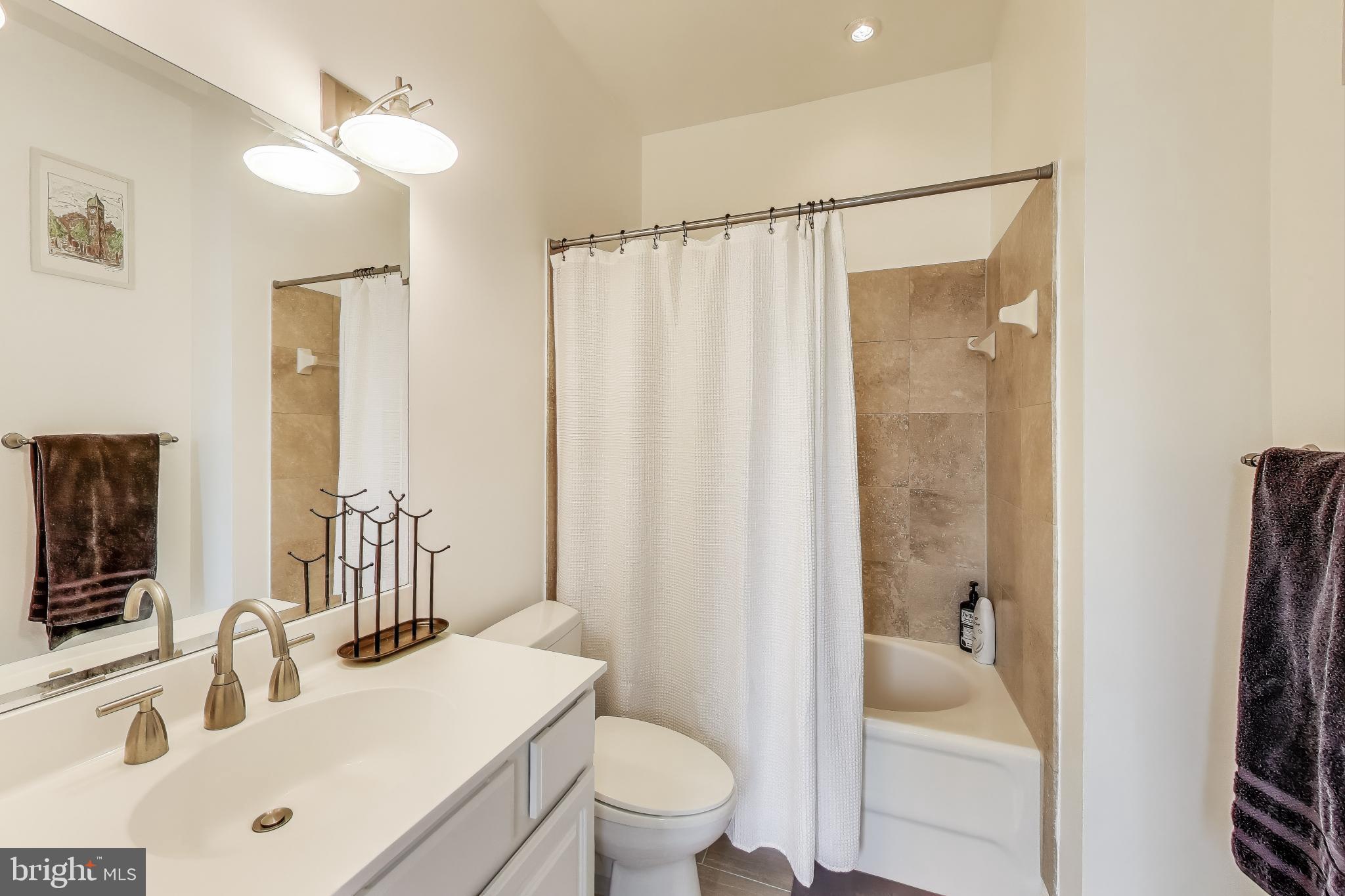 1406 T Street Northwest, Unit 6 Washington, DC 20009 - Photo 27 of 31 a bathroom with a sink toilet tub and shower