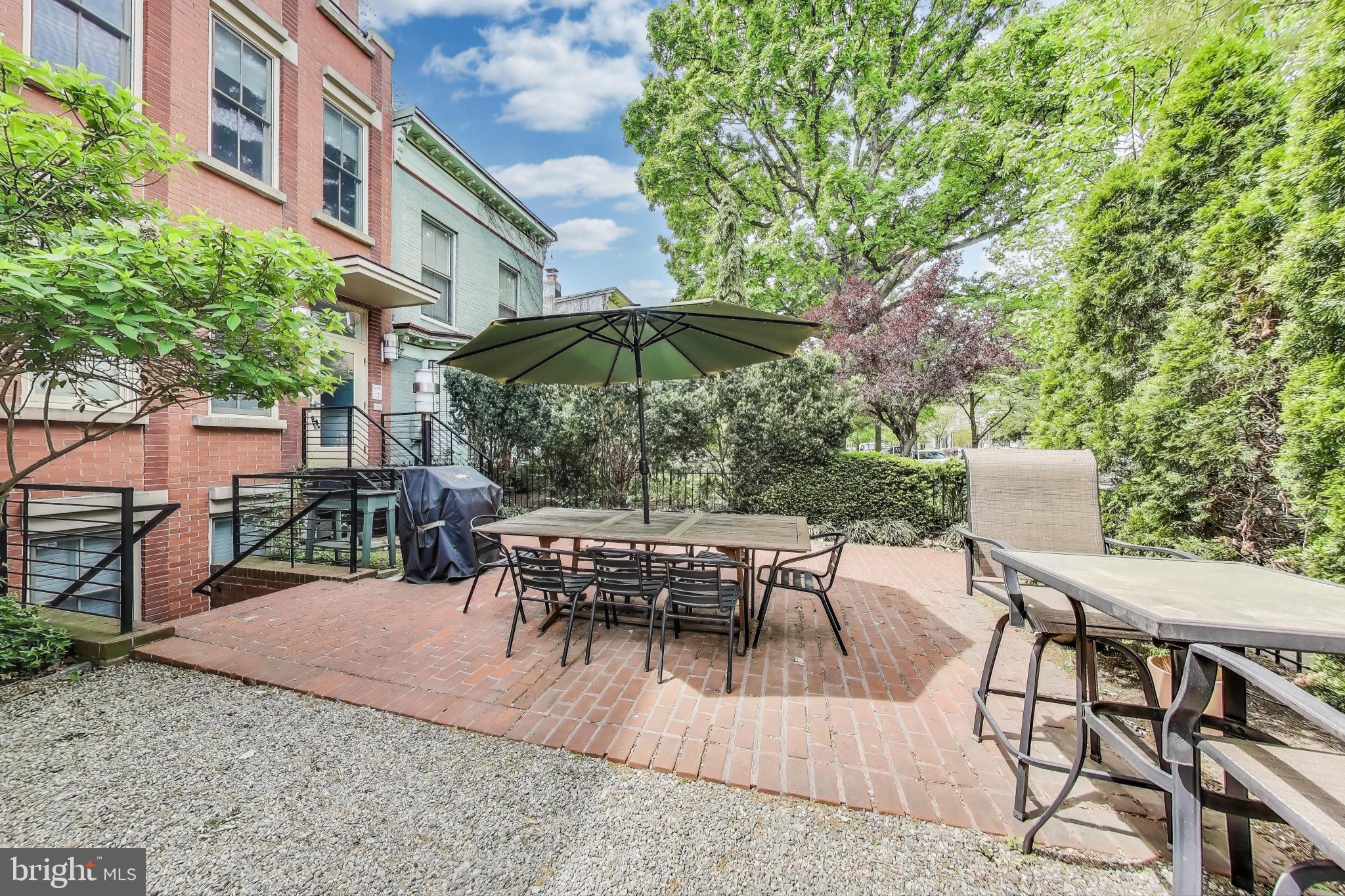 1406 T Street Northwest, Unit 6 Washington, DC 20009 - Photo 4 of 31 a view of a patio with a table and chairs under an umbrella