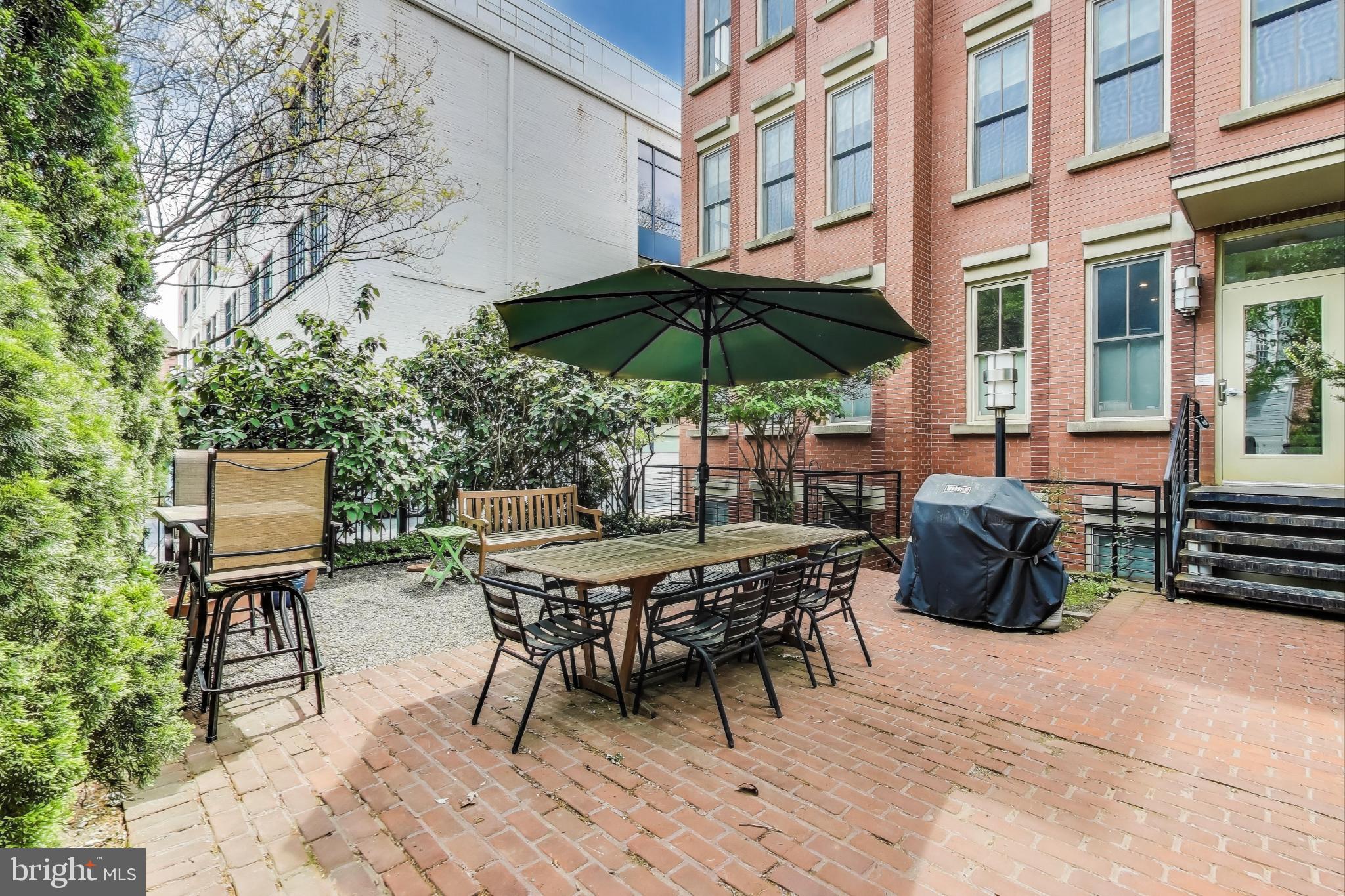 1406 T Street Northwest, Unit 6 Washington, DC 20009 - Photo 5 of 31 a view of patio with chairs and table under an umbrella