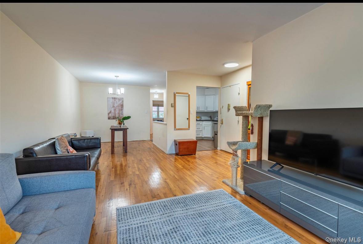 18-16 Bell Boulevard, Unit 3 Queens, NY 11360 - Photo 5 of 12 a living room with furniture and a flat screen tv
