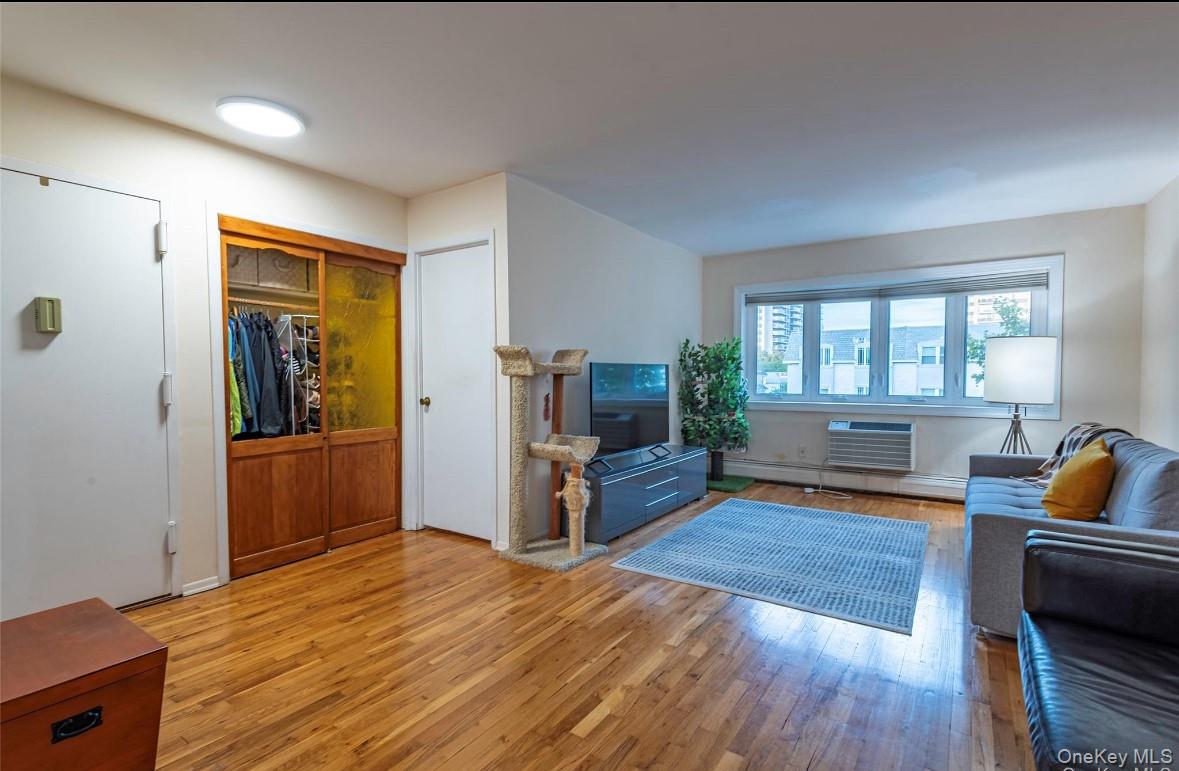 18-16 Bell Boulevard, Unit 3 Queens, NY 11360 - Photo 6 of 12 a living room with furniture and a flat screen tv