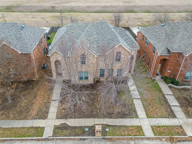 a aerial view of a house with a yard