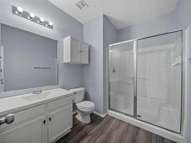 a bathroom with a toilet a sink and shower