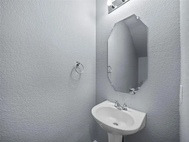 a bathroom with a sink and mirror