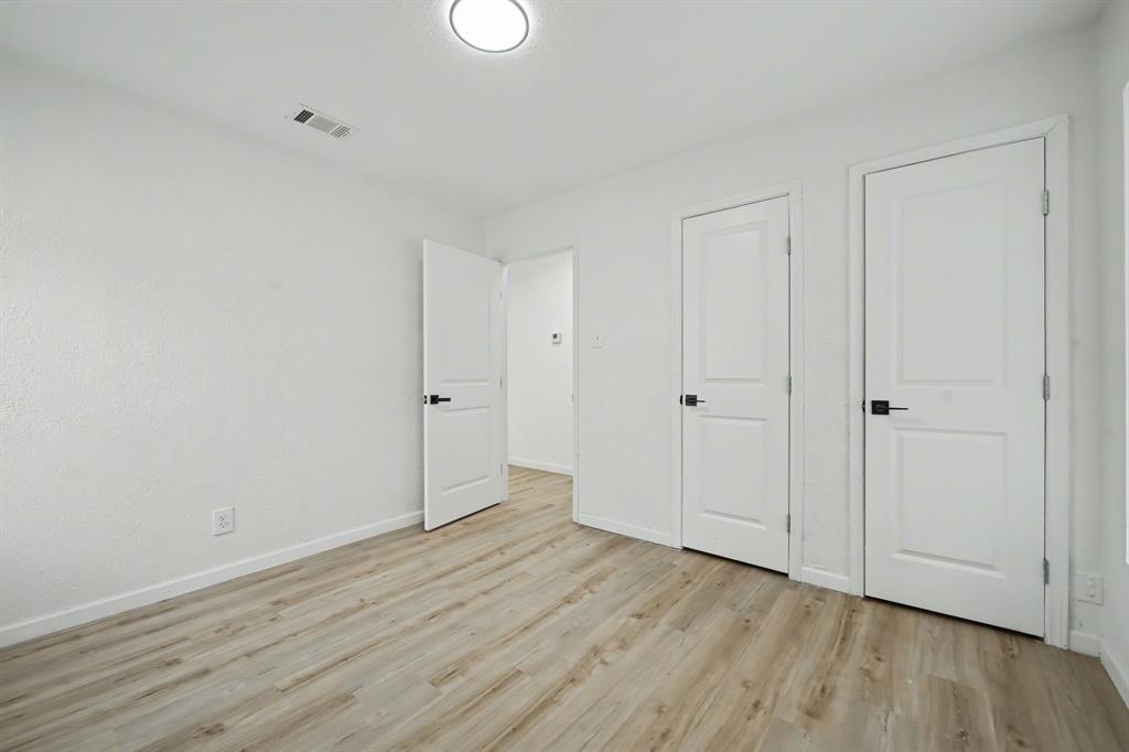 11446 Lippitt Avenue Dallas, TX 75218 - Photo 20 of 26 a view of an empty room with wooden floor