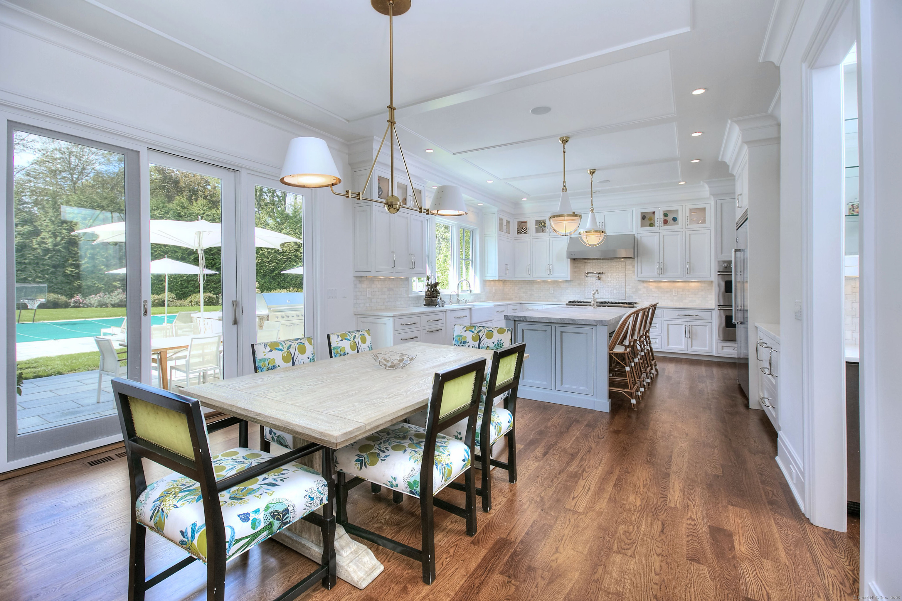 10 Debra Lane Westport, CT 06880 - Photo 18 of 40 a view of a dining room and livingroom with furniture wooden floor a chandelier