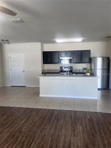 a kitchen with stainless steel appliances a refrigerator sink and microwave