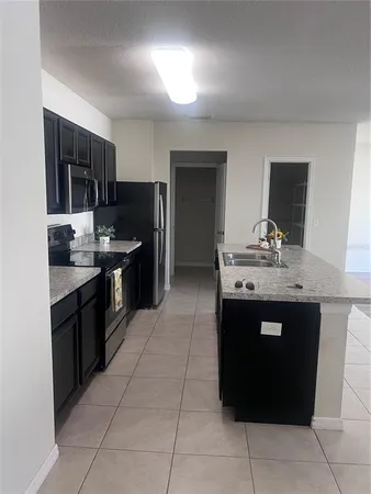a kitchen with a sink counter top space and appliances