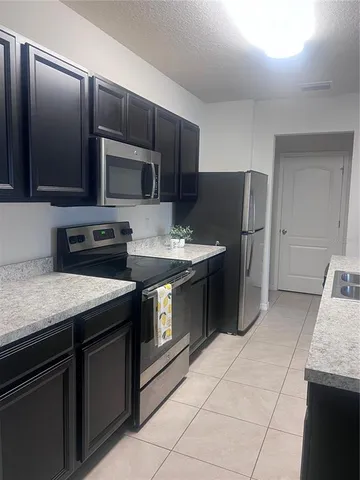 a kitchen with a sink and a stove top oven