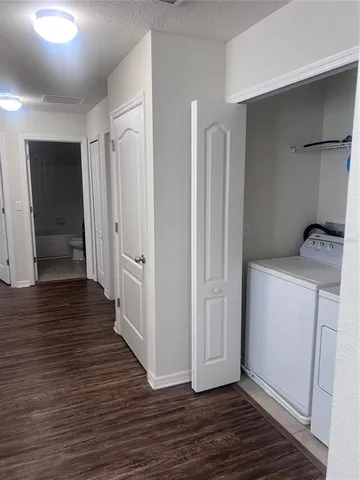 a view of hallway with wooden floor
