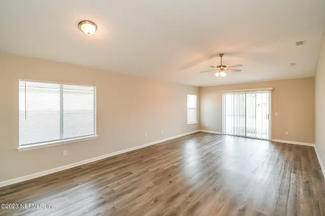 wooden floor in an empty room with a window