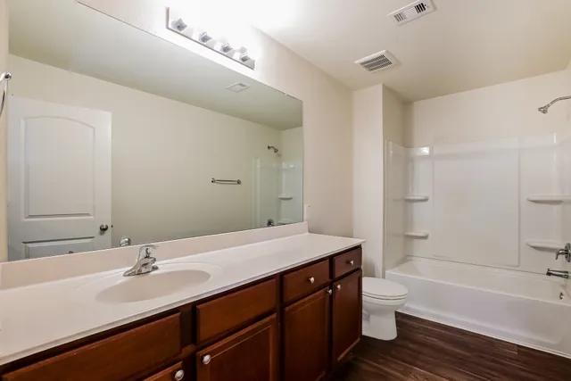 a bathroom with a sink a toilet and a bathtub