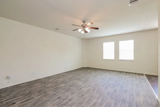 wooden floor in an empty room with a window