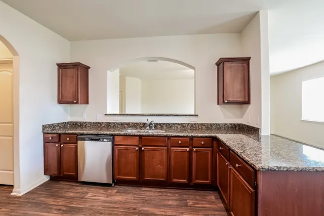 a kitchen with a sink and a wooden cabinets