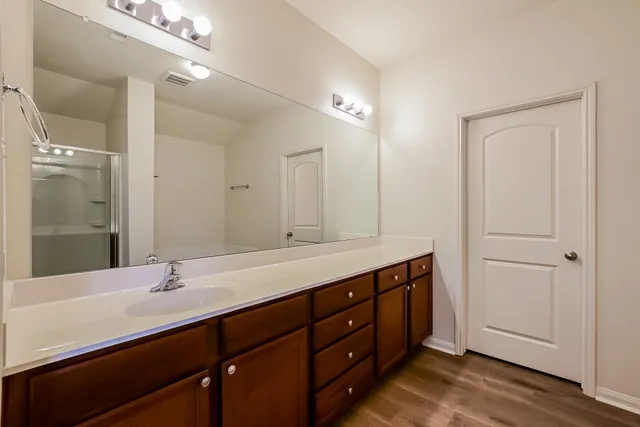 a bathroom with a double vanity sink and a mirror