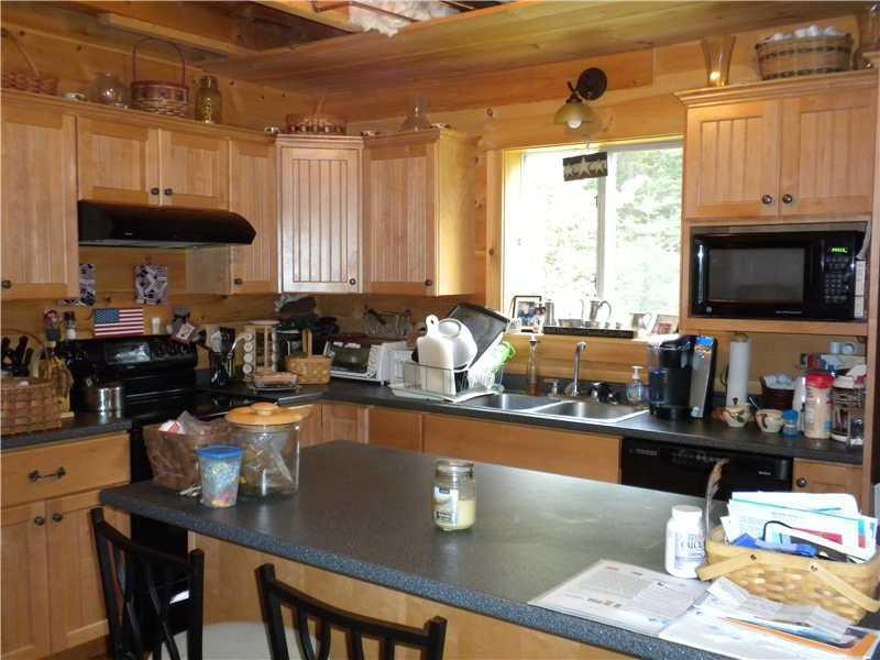 9 Cottage Road Rangeley, ME 04970 - Photo 2 of 11 Kitchen. Custom cabinetry offers...
