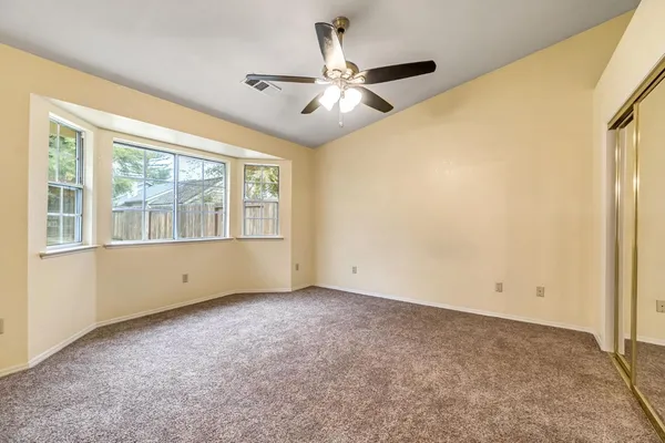 a view of a livingroom with a ceiling fan and window